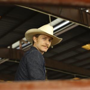 James Hebert poses for a portrait in a rodeo arena while working on his horsemanship back home.