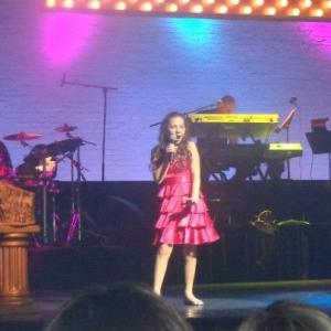 Rebecca singing on stage at the Apollo Theater