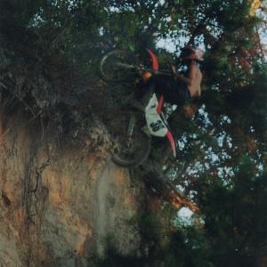 Climbing a rock cliff on a dirt bike