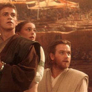 Just as their fate seems sealed, Anakin Skywalker (actor Hayden Christensen), Padmé Amidala (actress Natalie Portman), and Obi-Wan-Kenobi (actor Ewan McGregor) look up to see the Geonosis arena filled with Jedi rescuers.