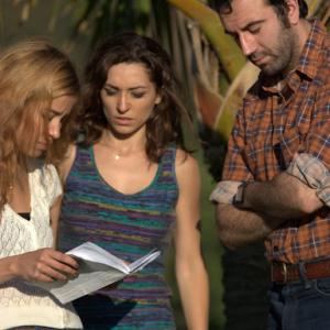Director Alexandra Bognar and actors Carlotta Montanari and Daniel Van Thomas consult a script on the set of Trash