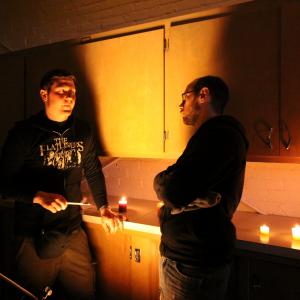 Cowritercodirector team John Pata and Adam Bartlett stand in while director of photography Travis Auclair adjusts lighting on the set of Dead Weight