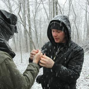 Assisting director of photography Travis Auclair put his glove on while filming during a blizzard