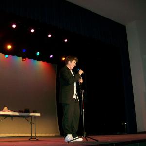 David on stage performing Stand Up comedy.