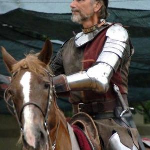 Richard P Alvarez  on horse and directing a live action joust in performance