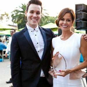 Television host Matthew Hoffman presents Brooke Burke Charvet with an award at the American Cancer Society Gala