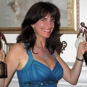 Cynthia Daddona at home working out with her two Telly Awards.