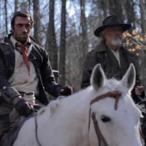 The Preacher (Daniel Van Thomas) and Edwards (Daniel Britt) on horseback. (Official Still)