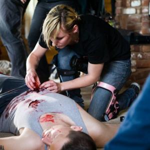 FX Makeup artist Carleigh Herbert applying blood to Haris Mahic in the film 
