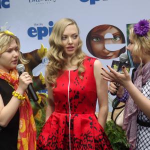 Cailin Loesch right and sister Hannah Loesch interviewing Amanda Seyfried at the NYC premiere of Epic