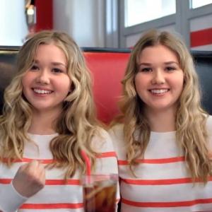 Still of Cailin Loesch (left) and sister Hannah Loesch in new Papa John's TV commercial