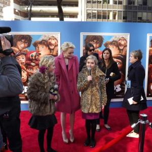 Cailin Loesch left and twin sister Hannah Loesch interviewing Emma Stone at the NYC film premiere of The Croods