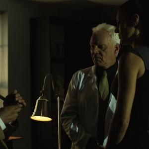 Still from Zombex with Pierre Kennel, Malcolm McDowell, and Emily Kaye