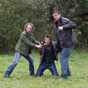 Sinister Man (Kyle Mitchell) and Heavy (Robert Maillet) hold Nathan Wuornos (Lucas Bryant) for a beating. Haven TV Show - 2013 Episode 413.