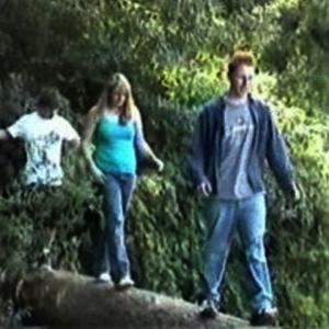 Cody, Chris and Brittany cross a log while chasing after Shane.
