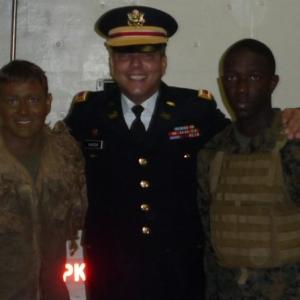 John Mancini as himself as an Army 1LT flanked by two Marines.
