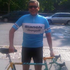 John Mancini as a cyclist on the set of 