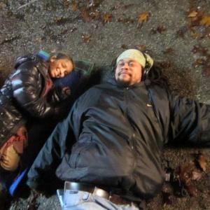 Director Seith Mann Joins Olivia Steele Falconer on the ground before shooting a scene. Falling Skies, Death March