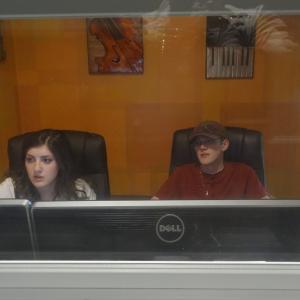 Shot from inside the sound booth shows the exhausted pair Sound Engineer Mary Rose Maher and Composer Nate Weil working hard into the night to meet the deadline