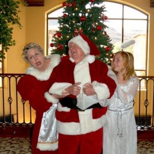 Megan Ashley as Lily with Santa Mickey Rooney and Mrs Clause Jan Rooney from the film Wreck the Halls
