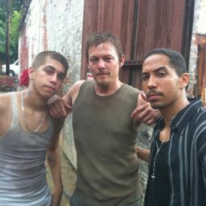 Anthony Guajardo, Norman Reedus, and Neil Brown Jr. on the set of The Walking Dead.