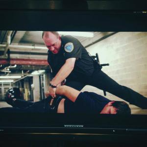 Screen grab of takedownhandcuff scene from Tragedy