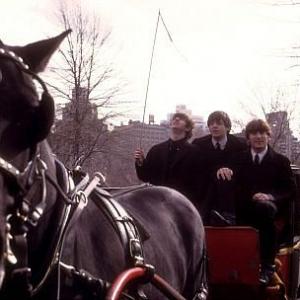 The Beatles ( Ringo Starr, Paul McCartney, John Lennon on a horse carriage ride. Ringo staring up at his whip)