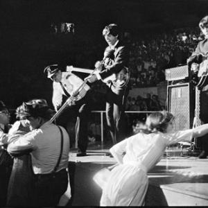 The Beatles' Paul McCartney and George Harrison performing live at a concert