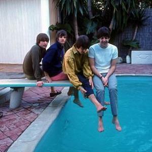 The Beatles (John Lennon, Ringo Starr, George Harrison, Paul McCartney) on the diving board by the poolside,