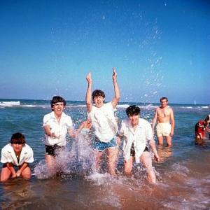 The Beatles (Ringo Starr, George Harrison, Paul McCartney, John Lennon, splashing around in public waters),