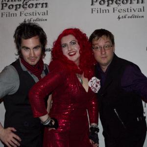 Photograph of Cassandra Sechler, Eric Falardeau, and Craig Jacobson at the black carpet ceremony for the 4th Annual Mascara and Popcorn Film Festival, 2013. http://www.mascaraandpopcorn.com/