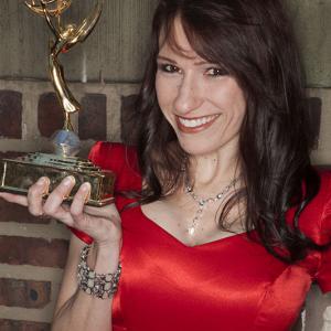 Jeni Miller holding Jeffrey Baxters Emmy Award for his work on Star Trek