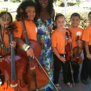 Nimi photographs with students at a music school program in San Diego, California
