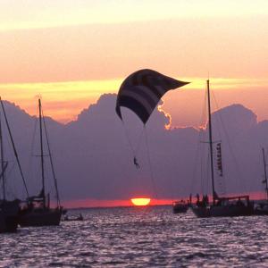 Took this photo at the Columbus Day Regatta on Biscayne Bay. No Photoshop was used, the guy was spinnaker flying as the sun was setting with actually about 1,000 boats anchored out for the night before the race back in the morning.
