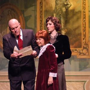Warbucks (Norman Large), Annie (Quinn Martin), and Grace Farrell (Christanna Rowader) in the musical Annie