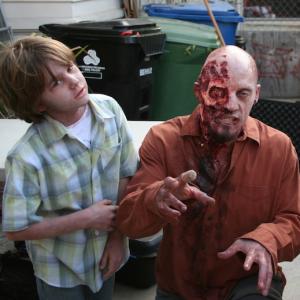 Aidan on the set of The Walking Dead with his zombie friend.