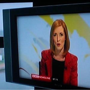 A scene from 'The Fall'. DSI Stella Gibson (Gillian Anderson) watches a news report. Newsreader - Brenda McNeill.