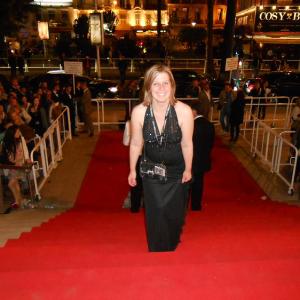 Whitney Mornson walking up the red carpet stairs at Cannes.