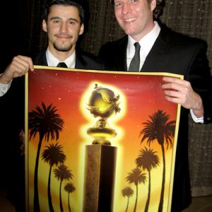 LR Producer Josh Wood and artist Colin McGreal hold signed poster during a candid moment at the 66th Annual Golden Globe Awards held at the Beverly Hilton Hotel on January 11 2009
