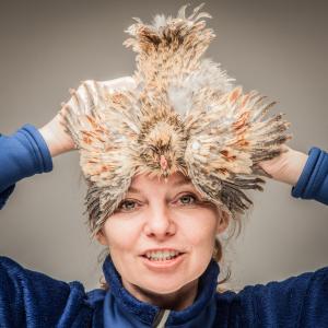 A live Swedish Flower Hen Frizzle pullet as a hat Why not?