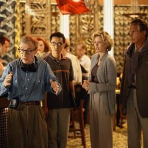 Director Val Waxman WOODY ALLEN left is trying to describe what he envisions for the next scene to left to right his cinematographers translator BARNEY CHENG and studio executives Ellie TA LEONI and Ed GEORGE HAMILTON in Woody Allens latest contemporary comedy HOLLYWOOD ENDING being distributed domestically by DreamWorks
