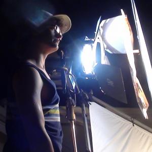 Logan adjusting a light on the set of marriage material
