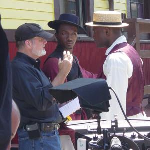 Young American Heroes director Chris Campbell gives direction to Jamie Hector center who plays Frederick Douglass and Jeff Greene who plays a sailor who helps Douglass escape to freedom in this scene shot on location at the Essex Steam Train Conn