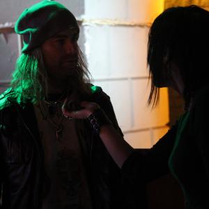 actor Bryan David playing rocker character Jackson Kincade and actress Michaela Paxton Tarbell playing goth gal Hanna Martin tempting him in the feature film House of Forbidden Secrets