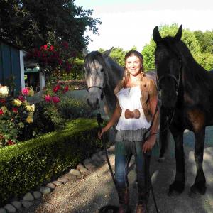 Christa with two of her movie horses, the Andalusian Gwenevierre and the Friesian, Juliet.