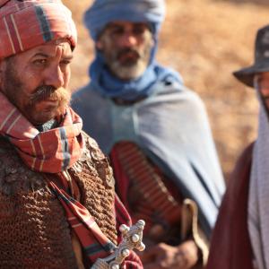 Magrouf (Driss Roukhe) with Ali (Riz Ahmed) and other tribes men