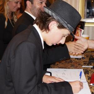 Brady Bryson signing copies of the script for auction after the premiere of Diamonds to Dust