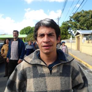 A Bolivian student marches towards a protest, in the film, Our Brand Is Our Crisis.