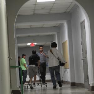 Martin Lemaire and Michael Scott Andrews run backwards as Michael Dunsworth runs down the hallway on the set of Hide Liam A Miller and Daniel Curtis look on