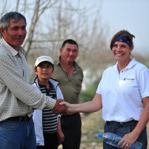Associate Producer/Production Manager Nancy Singleton Case meets with Uzbek farmer and son in orchard outside Fargona, Uzbekistan